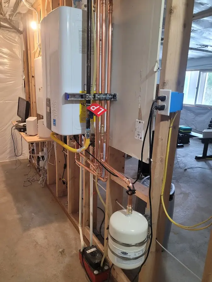 Licensed plumber repairing a kitchen sink in Bedford