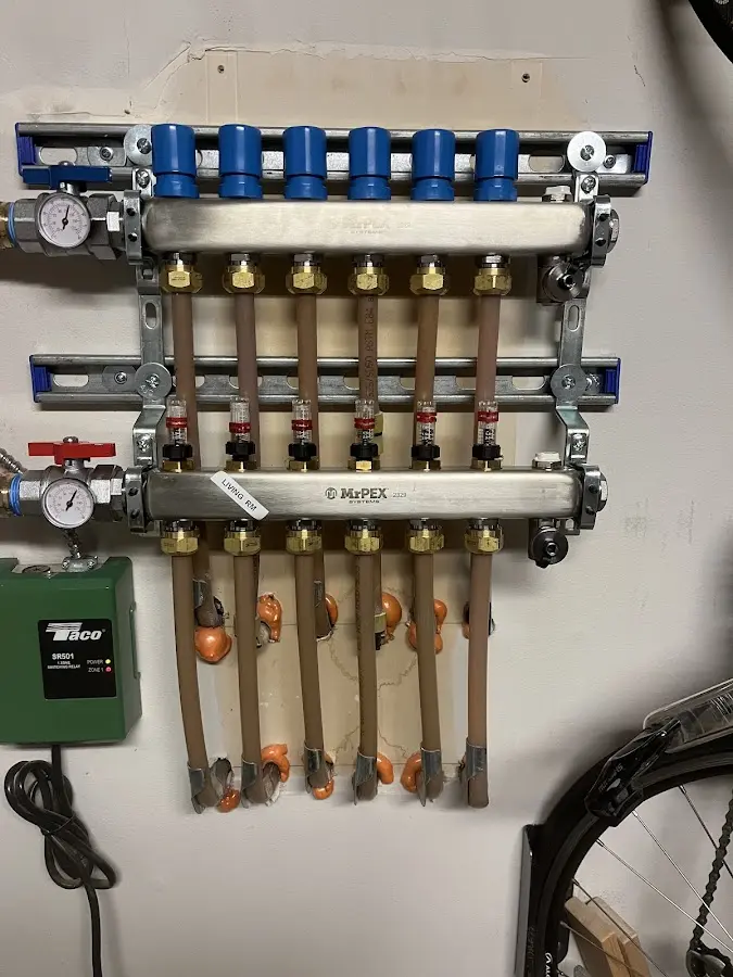 Plumber performing Water Heater Repair at a residential property in Bedford